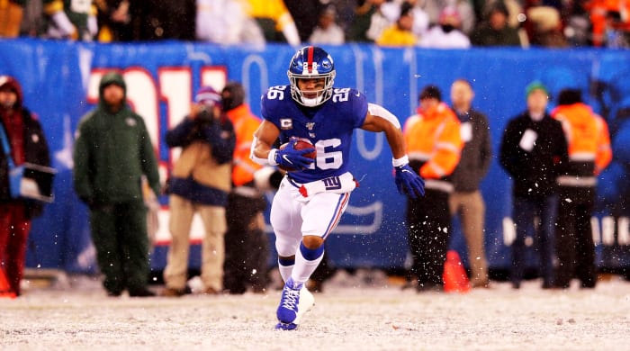 Dec 1, 2019; East Rutherford, NJ, USA; New York Giants running back Saquon Barkley (26) runs the ball against the Green Bay Packers during the fourth quarter at MetLife Stadium. Mandatory Credit: Brad Penner-USA TODAY Sports